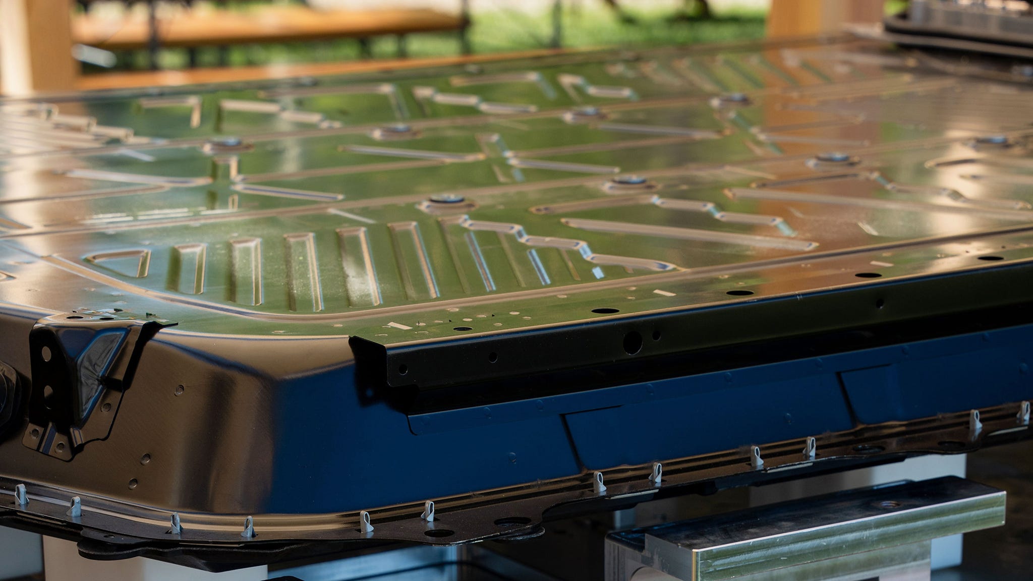 Close-up of a metal panel with intricate designs on a stand.