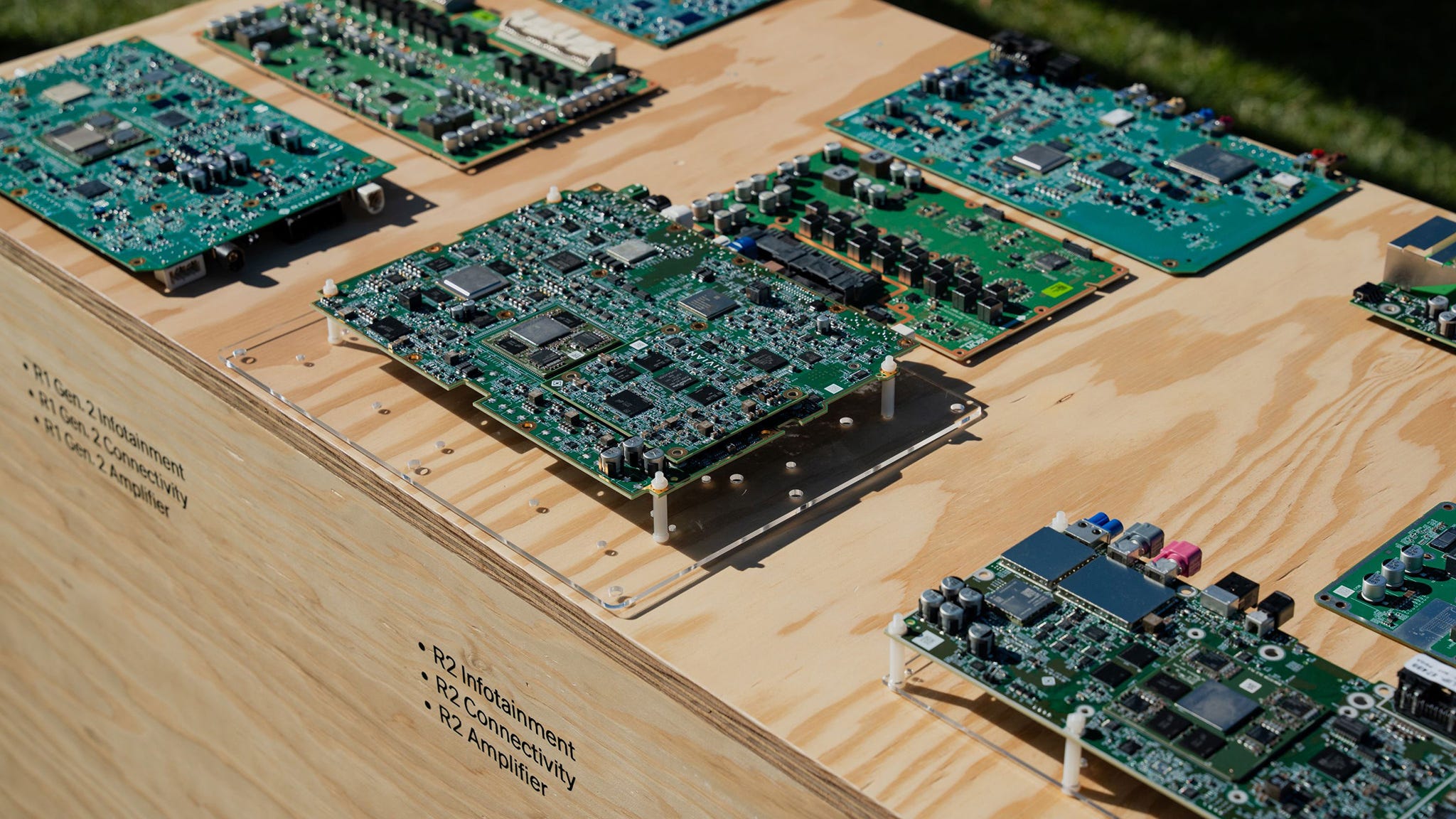 Various circuit boards displayed on a wooden surface.
